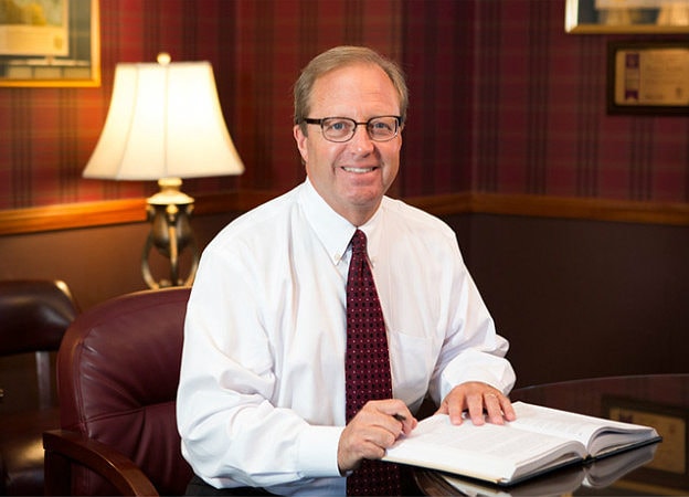 Columbus Workers comp attorney, Tom Marchese, sitting at his desk in his office in Dublin Ohio