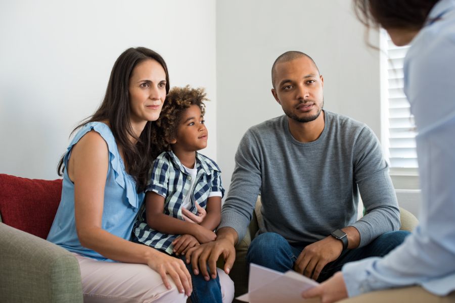 A family talking with a workers comp lawyer about death benefits after a fatal workplace injury