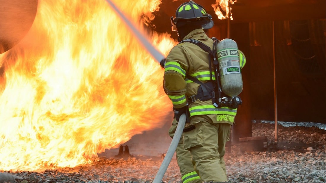 a firefighter and union member putting out a fire